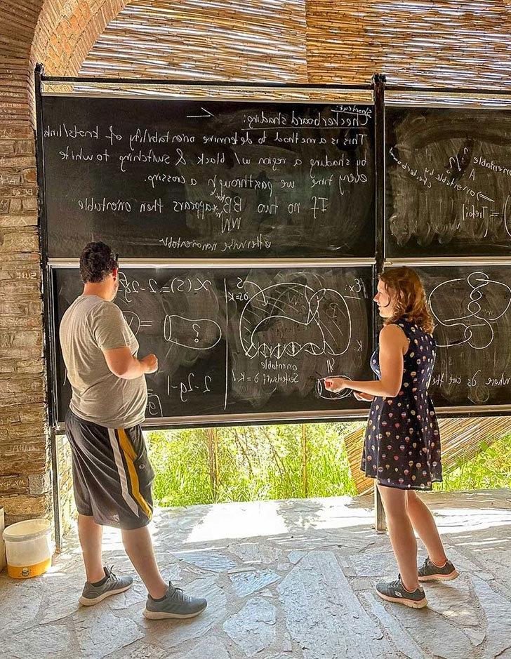 Caro harwell works on a math problem with an instructor